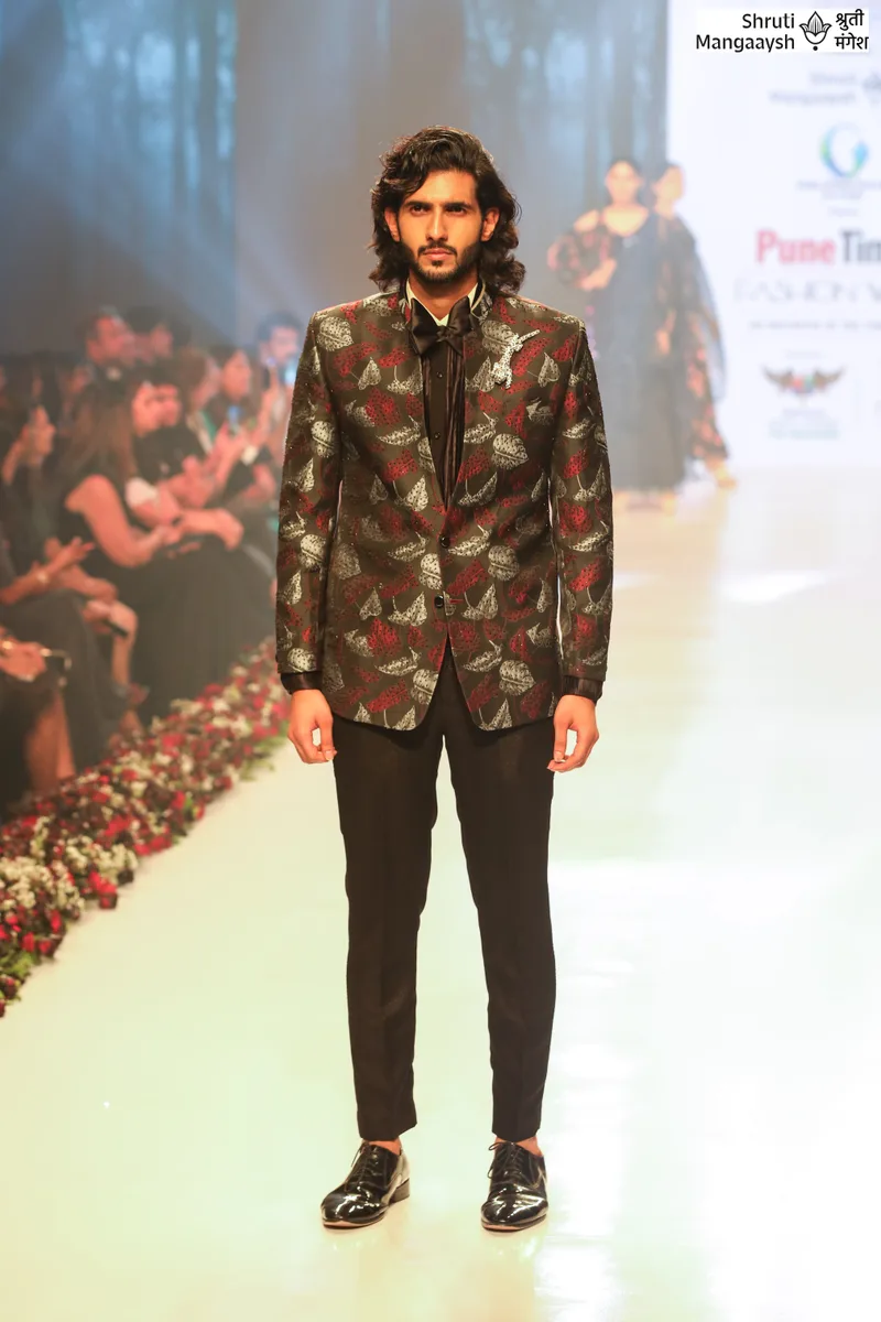 Model wearing a floral blazer with black trousers