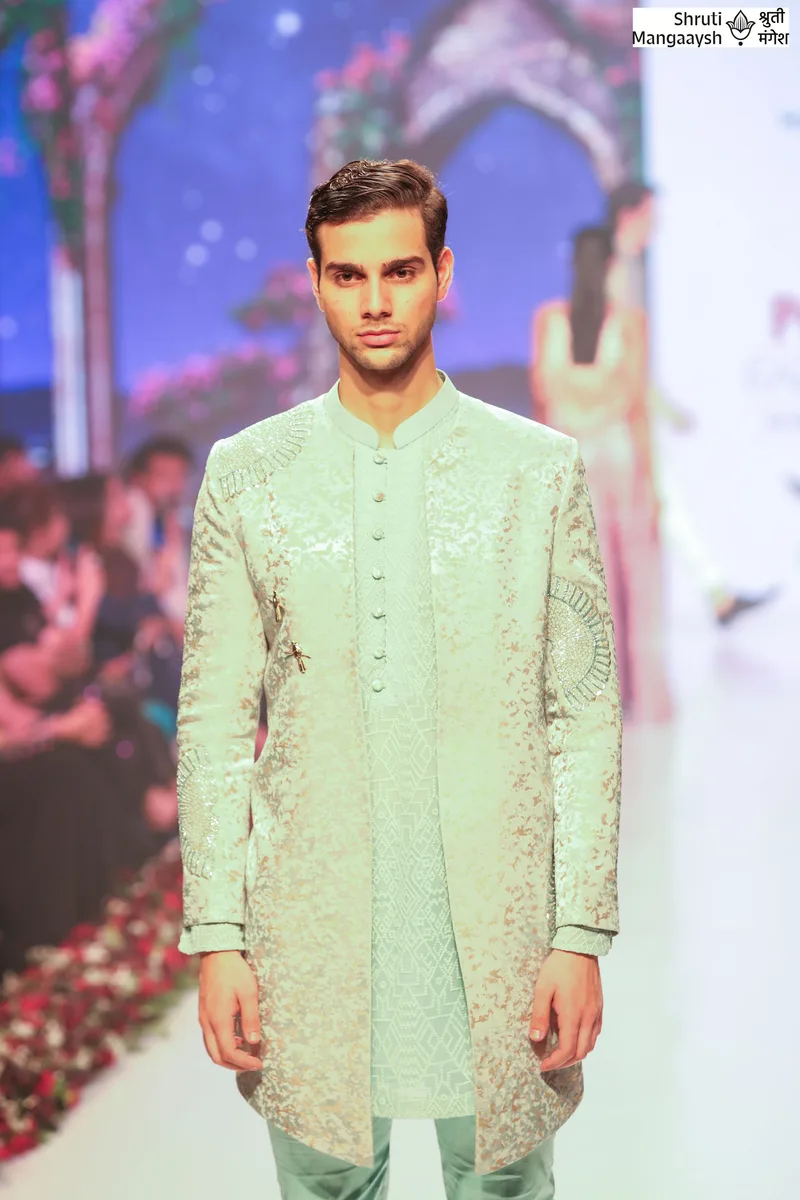 Close view of a pale green embroidered kurta on the runway