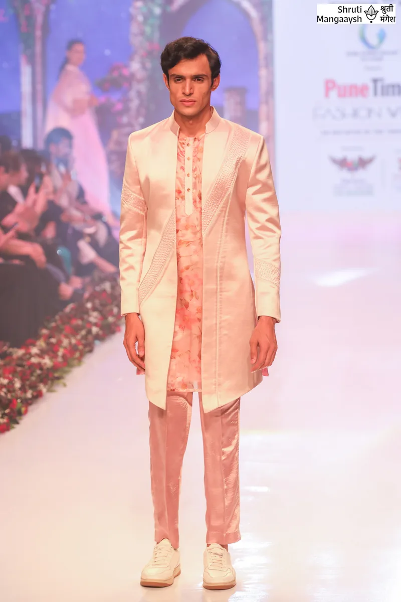 Model wearing a peach embroidered sherwani