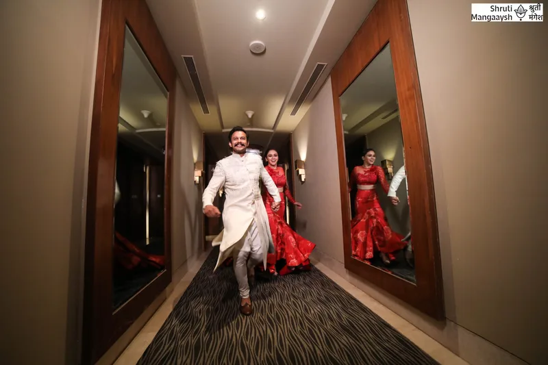 Model wearing an ivory outfit in a backstage corridor