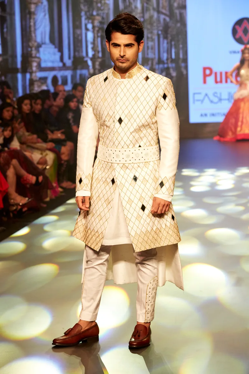 Model wearing an ivory patterned sherwani