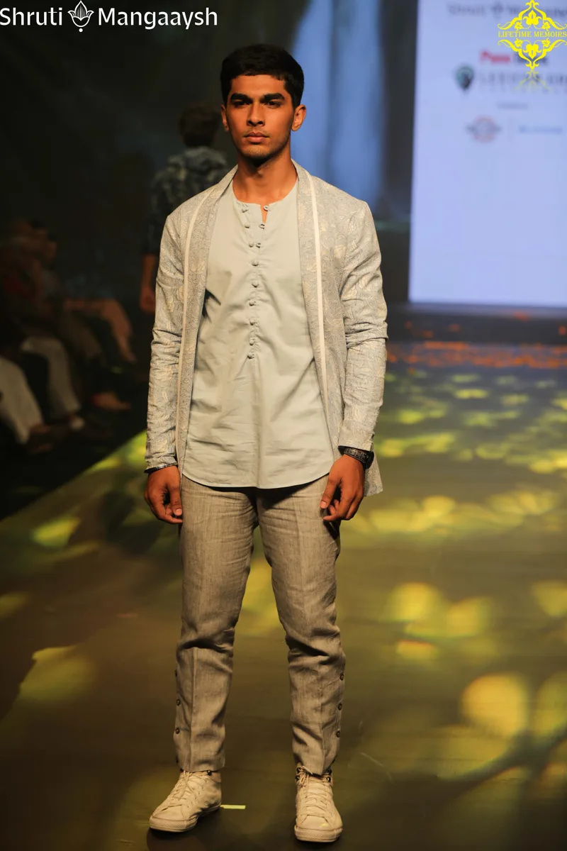 Model wearing a grey jacket with matching trousers