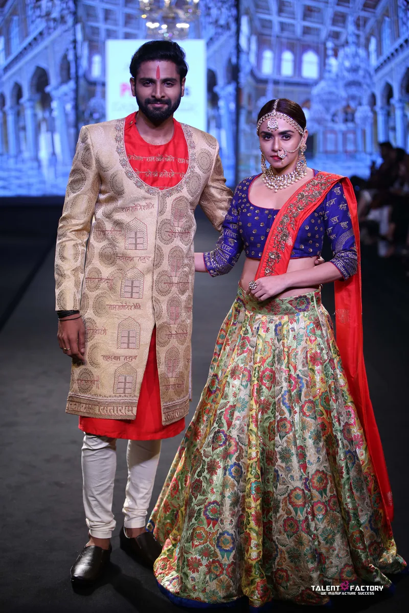 Gold sherwani and multicoloured floral lehenga on the runway