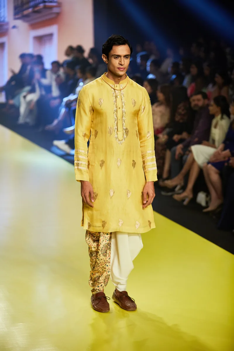 Model wearing a bright yellow embroidered kurta set