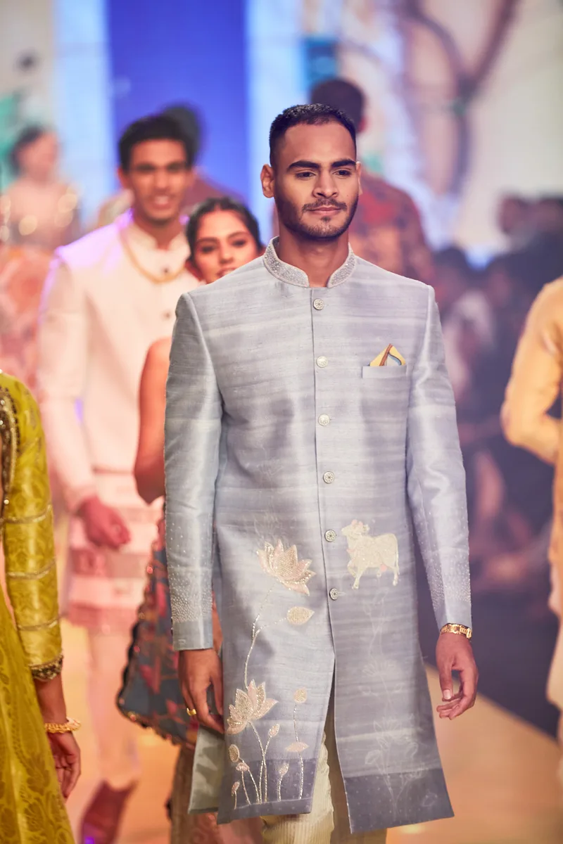 Close view of a pale blue sherwani with gold embroidery