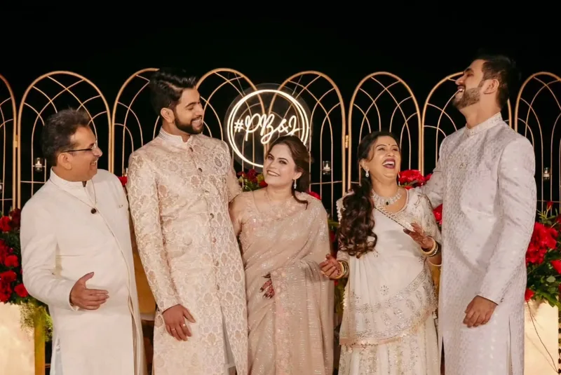 Wedding party wearing ivory and pastel outfits during an evening celebration